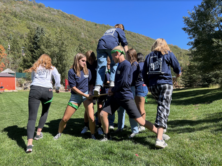 A group participates in the Human Stairs activity at Rotary Youth Leadership Awards conference. The goal of RYLA is to build leadership skills.
