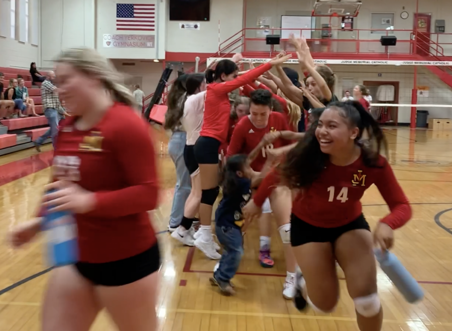 The volleyball team celebrates after a win over Rowland Hall.