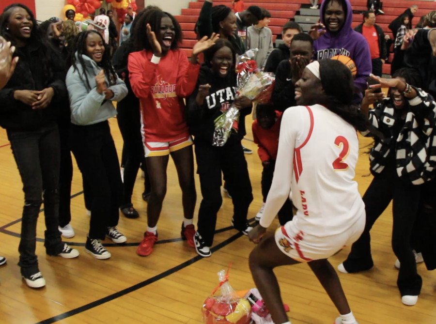 Nyandeng Deng celebrates after a win on senior nigh. Esther Analjok joins in with friends and family.