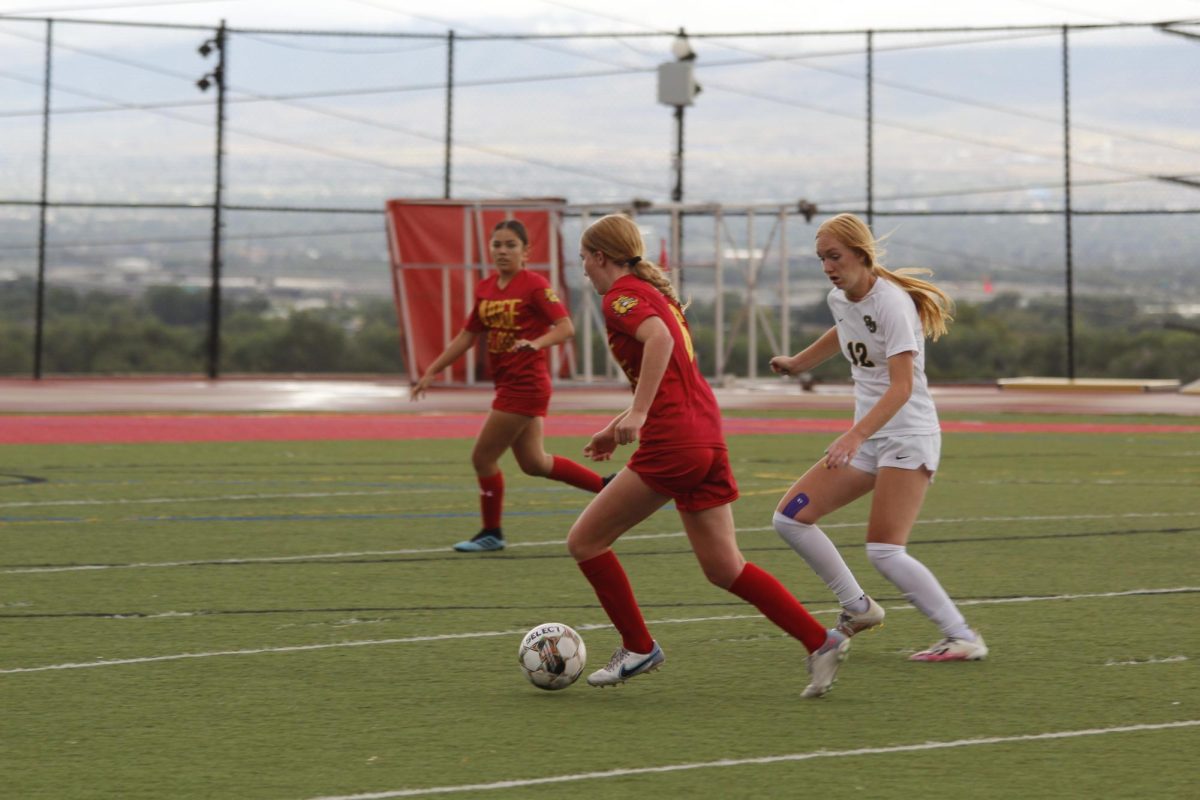 Lily Wikstrom sloshes the opposition, then passes to McKayla Kanuho. LIly had a goal in the first half, Judge's lone on the season.