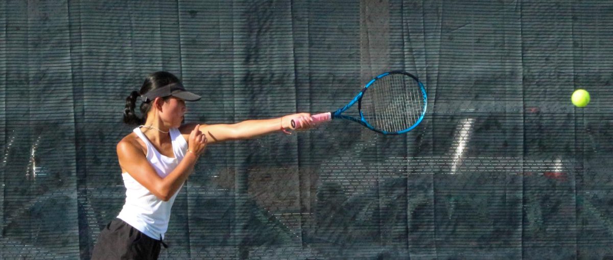 Grace Wilmarth returns a serve in a match at Logan on Aug. 25. The team went on to go undefeated in the region and are the Region 15 champions.