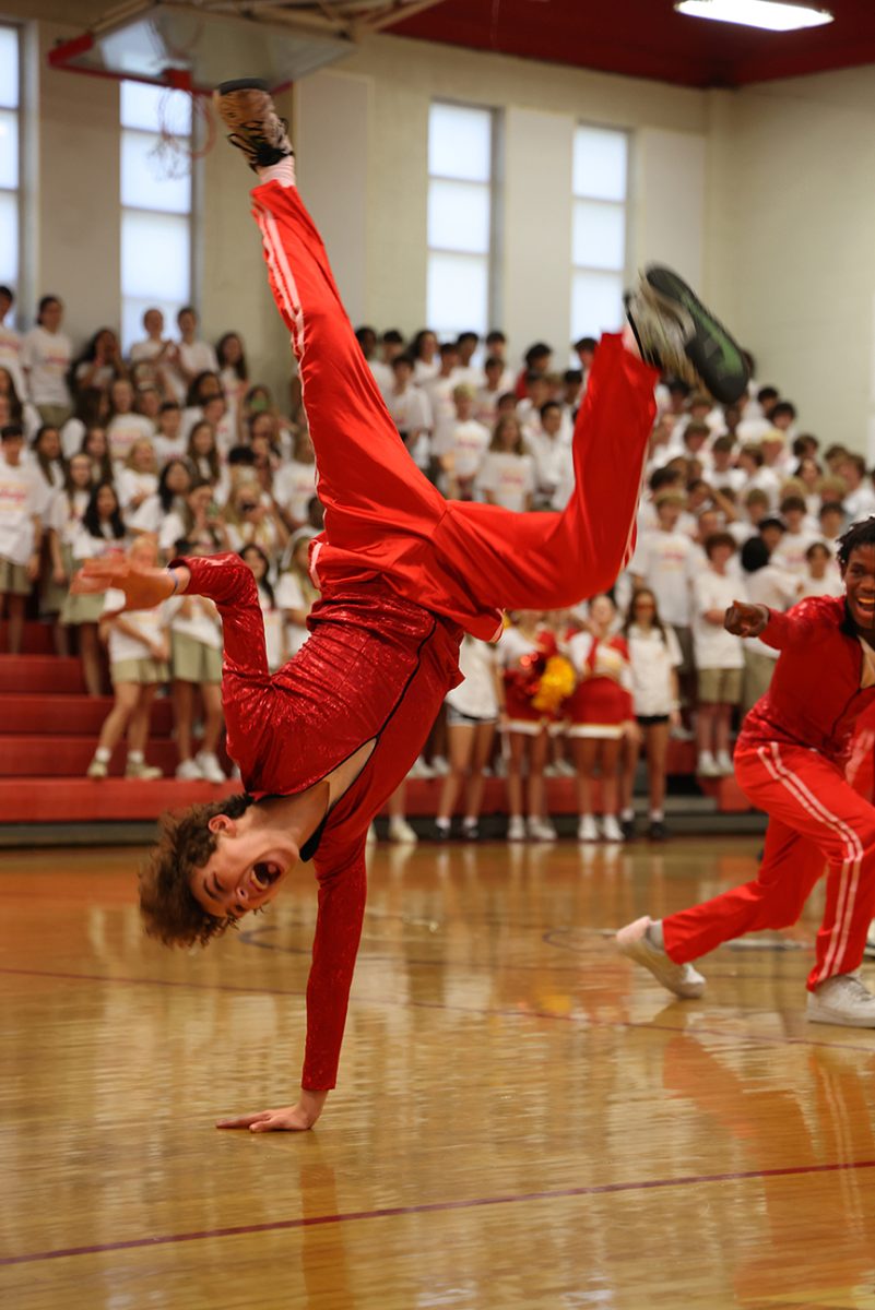 Rufus Cox does a handstand during the Mens Dance portion of the Homecoming assembly on Sept. 14.