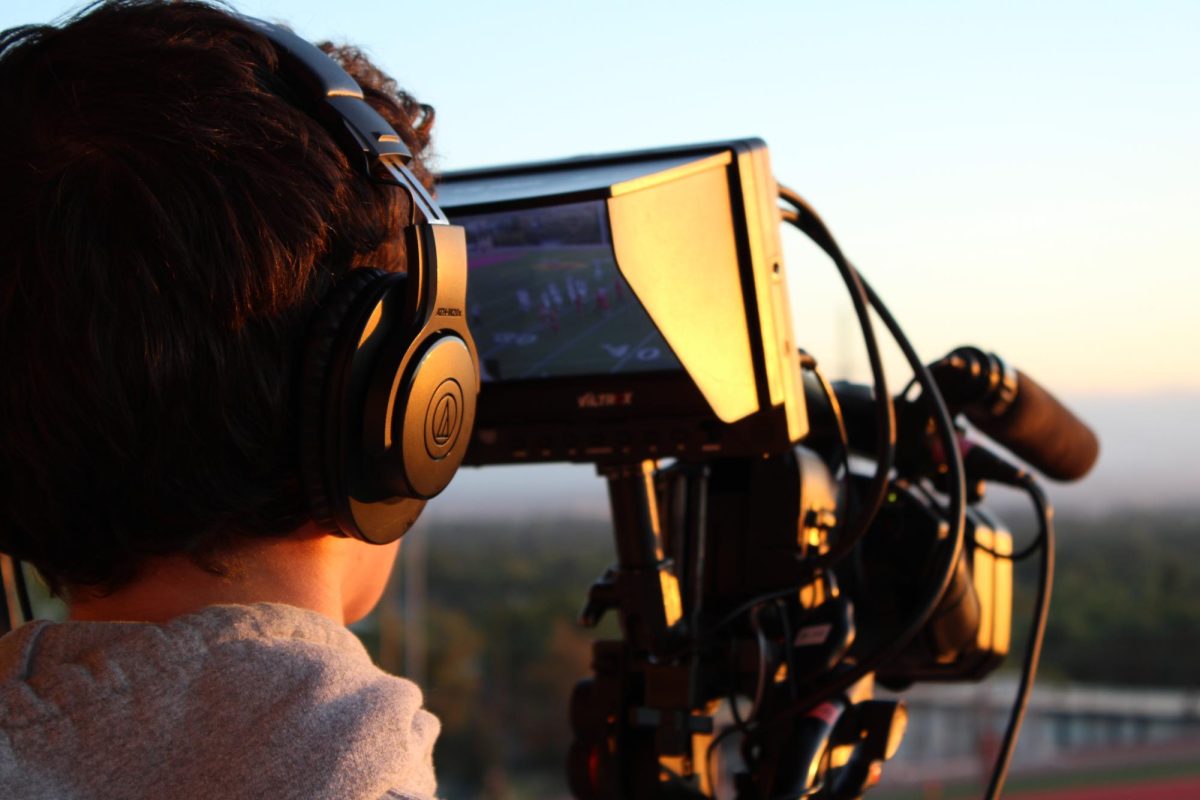 The cameraman at the Homecoming football game.