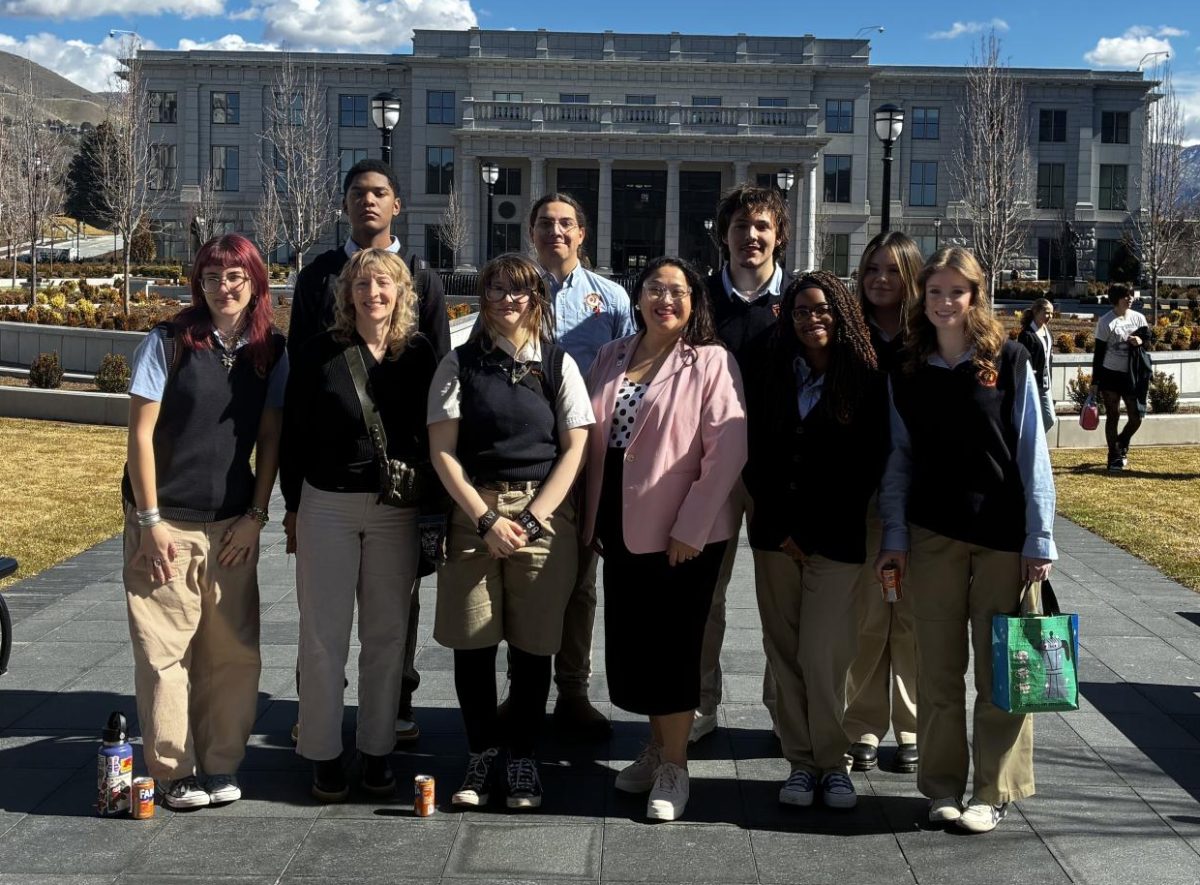 Some of the members of the Writing for Change class in front of the Utah Senate Building at the state capitol. Also pictured is Rep. Rosalba Dominguez.